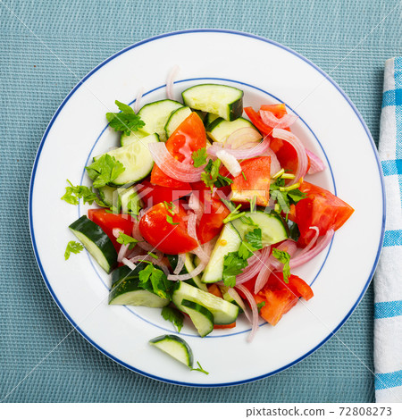Fresh salad with cucumbers, tomatoes and onion Fresh salad with cucumbers, tomatoes and onion 72808273