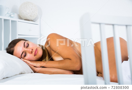 Woman sleeping in bed Woman sleeping in bed 72808300