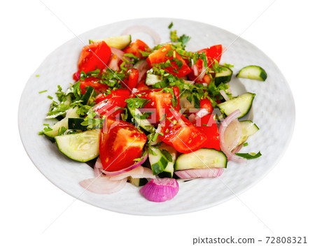 Delicious summer salad of cucumbers and tomatoes on plate Delicious summer salad of cucumbers and tomatoes on plate 72808321