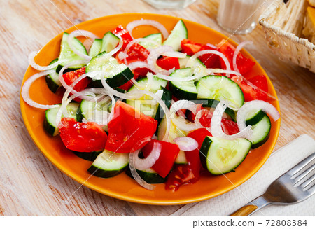 Vegetarian salad with fresh cucumbers, tomatoes, onion Vegetarian salad with fresh cucumbers, tomatoes, onion 72808384