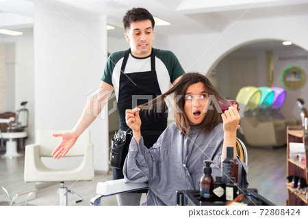 Displeased woman after haircut having conflict hairdresser Displeased woman after haircut having conflict hairdresser 72808424