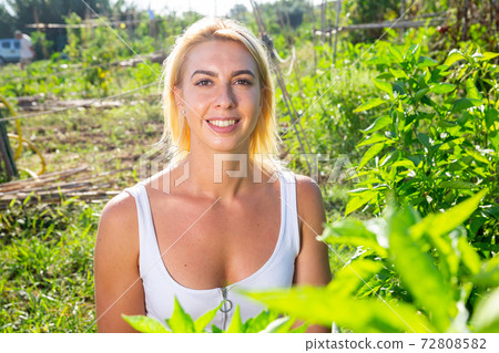 Young european female portrait in garden 72808582