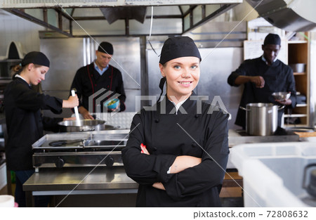 Confident young woman chef Confident young woman chef 72808632