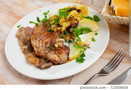 Steaks of pork loin with homestyle boiled potatoes Steaks of pork loin with homestyle boiled potatoes 72808689