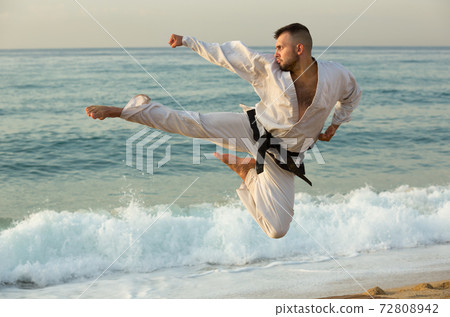 Man practising karate kata poses 72808942