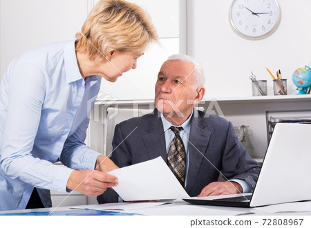 Aged manager working with secretary 72808967