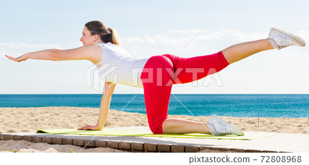 Woman doing yoga sitting 72808968