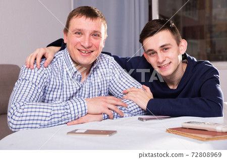 Portrait of guy with his father who are resting together 72808969