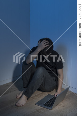 Laptop and man in a dark room Laptop and man in a dark room 72809091