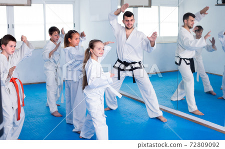 Young teenagers are practicing new moves by repeating for the trainer Young teenagers are practicing new moves by repeating for the trainer 72809092