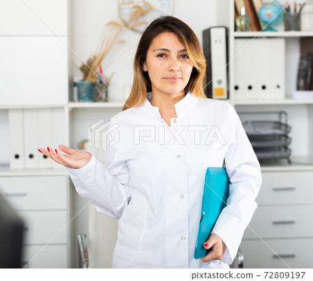 Female doctor welcoming to clinic Female doctor welcoming to clinic 72809197