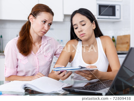 Mother supporting upset daughter Mother supporting upset daughter 72809438