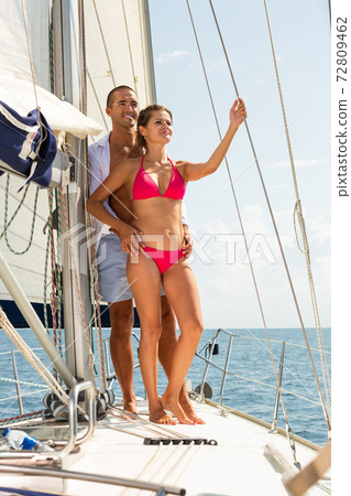 Couple enjoying sea trip on sailboat Couple enjoying sea trip on sailboat 72809462