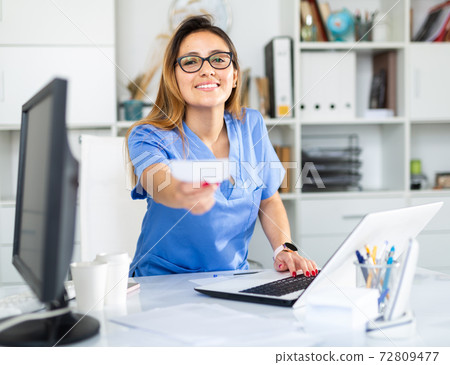 Colombian female doctor is giving recipe to client 72809477