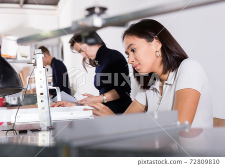 Female architect working on fret saw Female architect working on fret saw 72809810