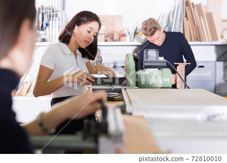Girl making details for architectural model on grinding machine Girl making details for architectural model on grinding machine 72810010