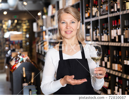 Woman owner of winery inviting to tasting wine Woman owner of winery inviting to tasting wine 72810087