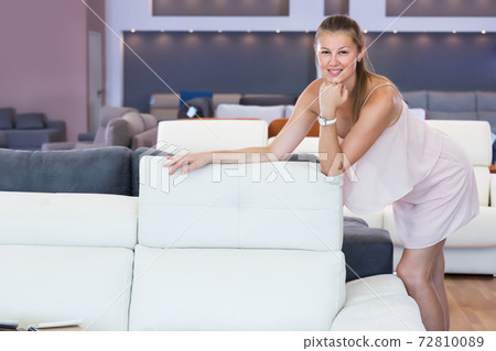 Portrait of adult woman consumer choosing sofa Portrait of adult woman consumer choosing sofa 72810089