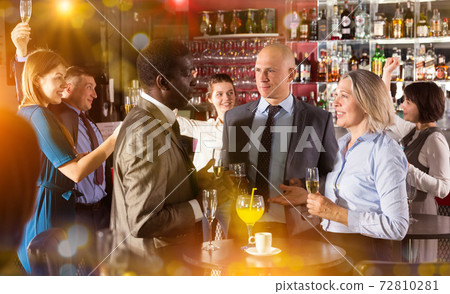 Executives talking at office party Executives talking at office party 72810281