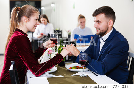Elegant female and her boyfriend are celebrating date for dinner Elegant female and her boyfriend are celebrating date for dinner 72810331
