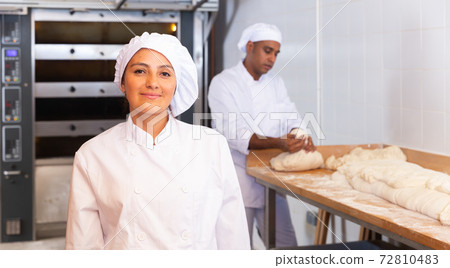 Smiling young hispanic female baker in bakery Smiling young hispanic female baker in bakery 72810483