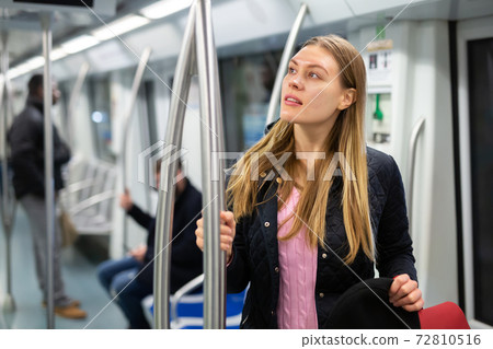 Young woman in subway car Young woman in subway car 72810516
