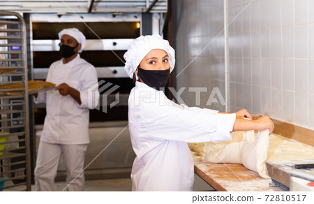 Woman baker kneading dough for baking bread Woman baker kneading dough for baking bread 72810517