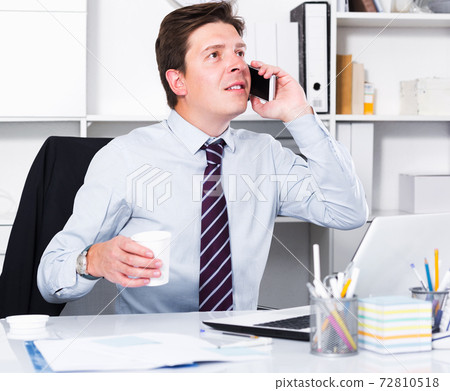 Businessman talking on phone Businessman talking on phone 72810518