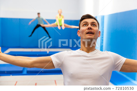 Portrait of excited man jumping on trampoline Portrait of excited man jumping on trampoline 72810530