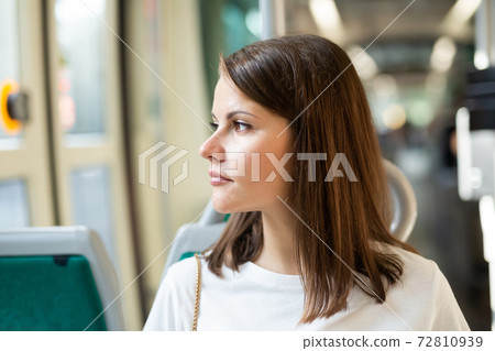 Woman traveling in modern streetcar 72810939