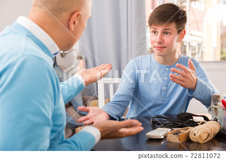 Son talking to father Son talking to father 72811072