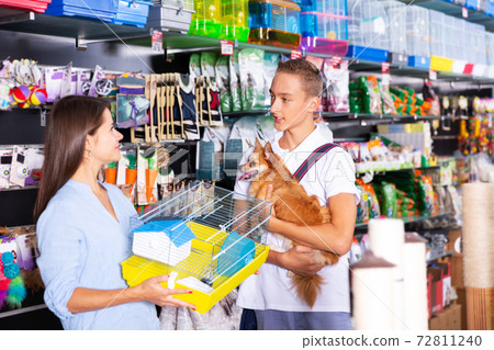 Woman with boy searching of birds cage Woman with boy searching of birds cage 72811240