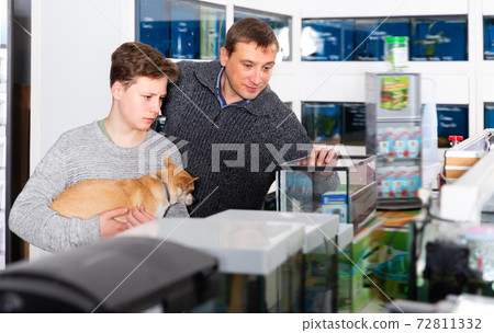 Happy man with son and dog buying pet supplies 72811332