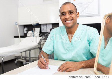 Beautician recording client cards at table in aesthetic cosmetology clinic Beautician recording client cards at table in aesthetic cosmetology clinic 72811367