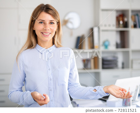 positive businesswoman speaking in white room positive businesswoman speaking in white room 72811521