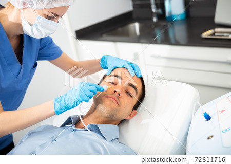 Man receiving carboxytherapy procedure at beauty clinic Man receiving carboxytherapy procedure at beauty clinic 72811716