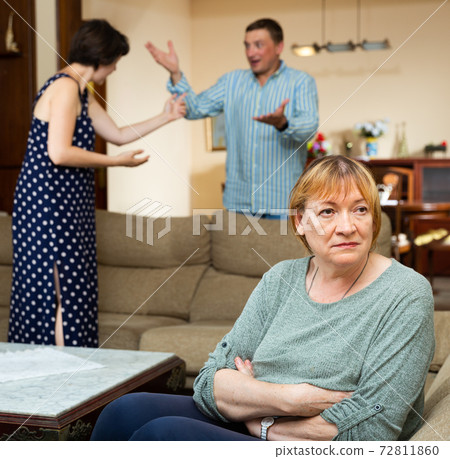 Unhappy senior woman sitting, emotional woman quarrel with man 72811860