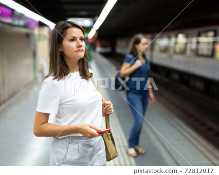 Pretty woman walks on the subway platform Pretty woman walks on the subway platform 72812017