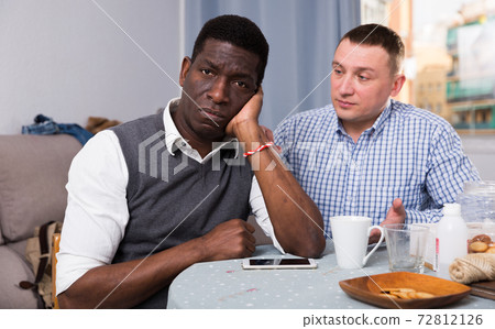 Man apologizing to his African friend Man apologizing to his African friend 72812126