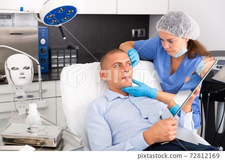 Man having consultation with doctor in clinic Man having consultation with doctor in clinic 72812169