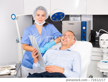 Woman doctor and male patient of clinic Woman doctor and male patient of clinic 72812217