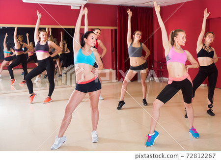 Young women performing modern dance in fitness studio 72812267