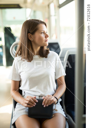 Woman traveling in modern streetcar Woman traveling in modern streetcar 72812616
