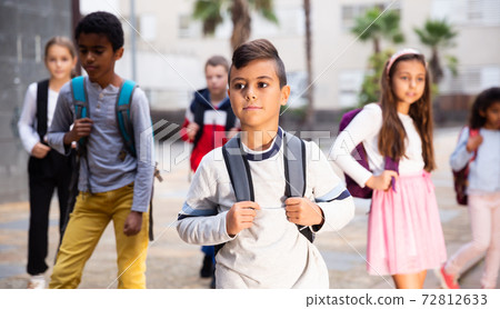 Portrait of preteen Hispanic boy with rucksack on his way to school Portrait of preteen Hispanic boy with rucksack on his way to school 72812633