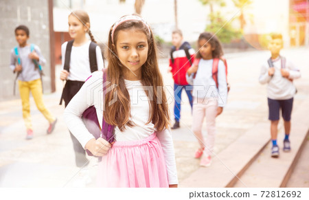 Teenage girl with backpack going to school on autumn day 72812692