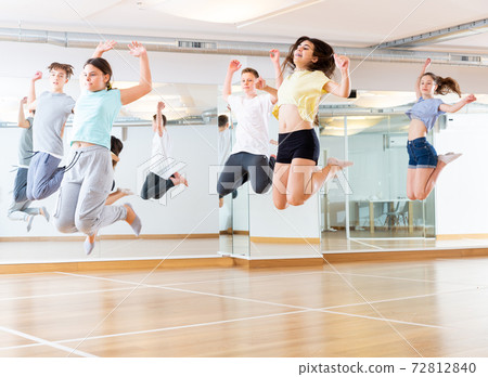 Group of young dancers jumping together in class Group of young dancers jumping together in class 72812840
