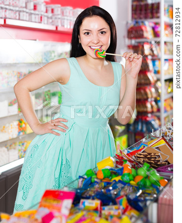sexy satisfied woman posing in the store with lolly 72812934