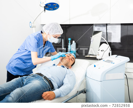 Man receiving carboxytherapy procedure at beauty clinic Man receiving carboxytherapy procedure at beauty clinic 72812938