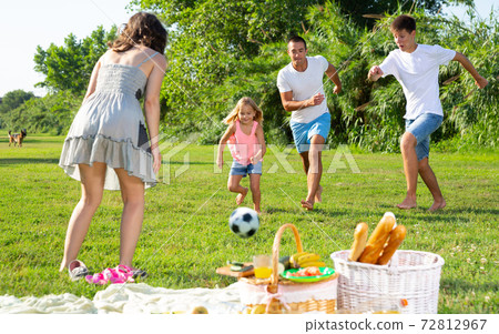 Happy family playing football Happy family playing football 72812967