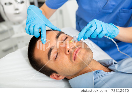 Man receiving carboxytherapy procedure at beauty clinic Man receiving carboxytherapy procedure at beauty clinic 72812970